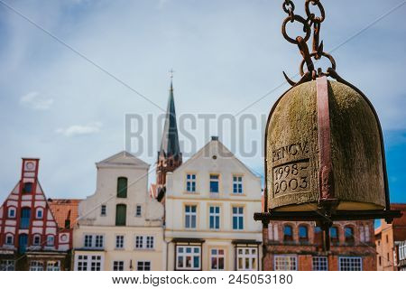 Weight Of Old Crane Hanging In Front Of Facade Of Historical Buildings In Harbor Lueneburg, Lower Sa