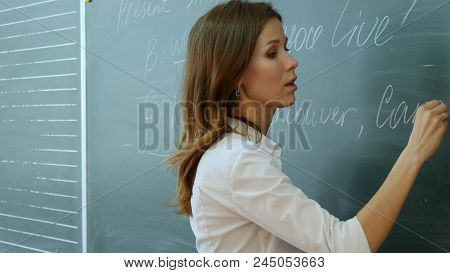 Teacher Writing On The Blackboard . Professional Shot On Lumix Gh4