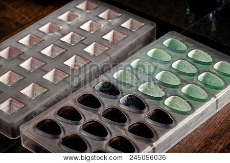 Confectionery And Cooking Tools For Sweets On Wooden Table. Plastic Moulds, Mixers, Food Colors, Mea