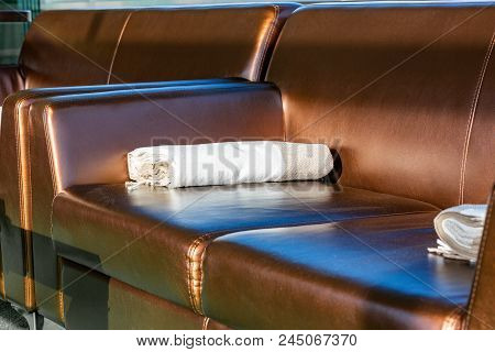 Close Up Modern Elegant Brown Leather Lounge Sofa With Woolen Throw Rug Blanket On The Arm. Interior