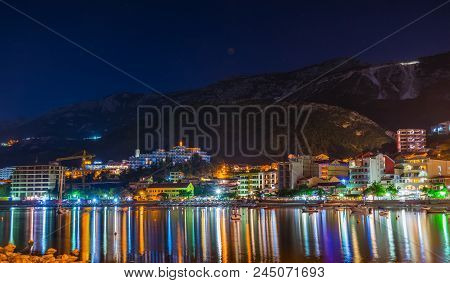 Montenegro, Rafailovici - June 05/2017: Tourists Walk Along The Picturesque Night Embankment On The