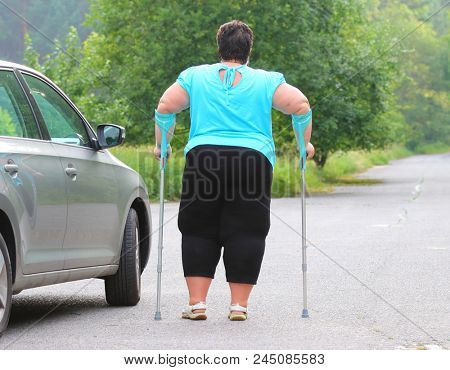 Disabled woman upgoing from a car. Transportation and travel for handicapped people.
