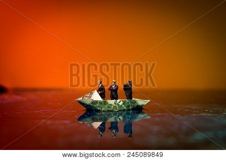 Miniature Figurine Businessmen Ride On Dollar Bill Origami Yacht