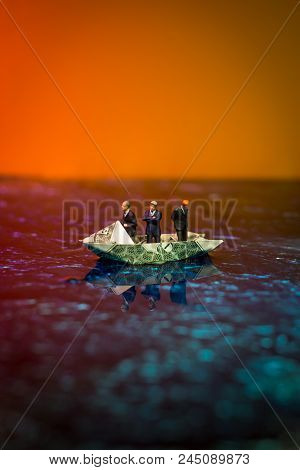 Miniature Figurine Businessmen Ride On Dollar Bill Origami Yacht