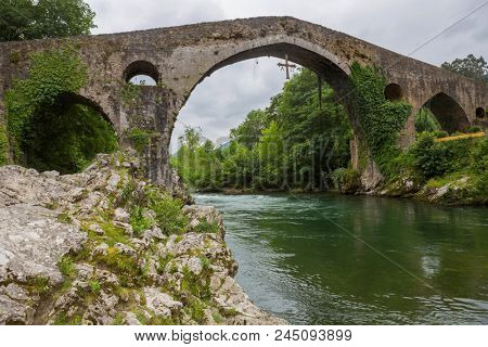 Roman bridge built in the late 13th century over the Sella River in Cangas de Onis, Asturias, Spain.