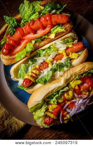 Fancy Grilled Hotdogs With Many Toppings Including Relish And Sauerkraut