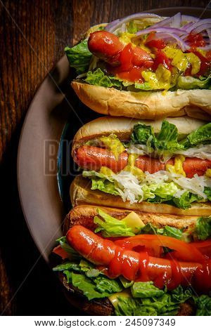 Fancy Grilled Hotdogs With Many Toppings Including Relish And Sauerkraut
