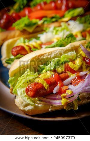 Fancy Grilled Hotdogs With Many Toppings Including Relish And Sauerkraut