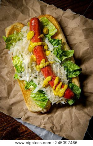 Fancy Grilled Hotdog With Sauerkraut Lettuce And Spicy Mustard
