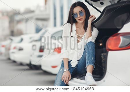 Beautiful Brunette Young Woman With Shopping Bag Near The White Super Car, Outdoors. Woman Standing 