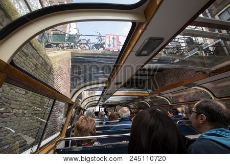 Amsterdam, Netherlands - April 20, 2017:a Tourboat Is Taking Tourists Around The Canals In Amsterdam