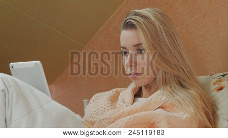 Young Female Patient Use Digital Tablet In Hospital Bed. Close