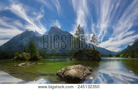 Hochkalter Mountain Group In The Bavarian Alps, Viewed From The Famous Hintersee Lake, With Feather 