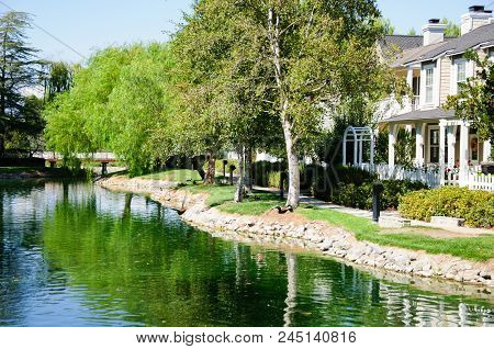 Beautiful House At Lake In Sunny Day, California