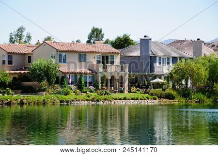 Beautiful House At Lake In Sunny Day, California