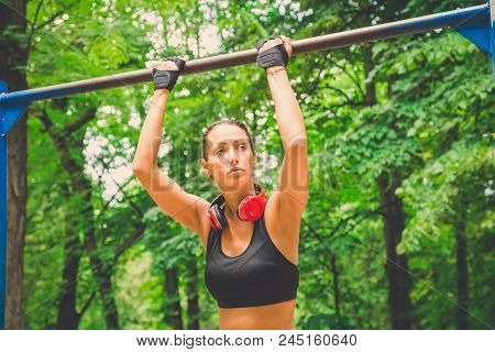 Fitness Woman Preparing For Doing Pullups In Nature. Healthy Lifestyle Concept.