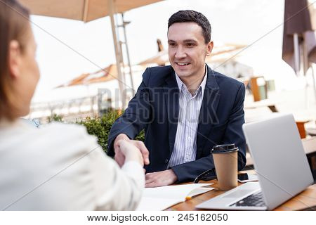 White Collar. Successful White Collar Worker Feeling Very Secure While Shaking Hand Of His Prosperou