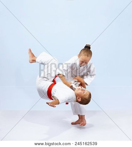 Children Athletes Train Judo Throws On The Light Background