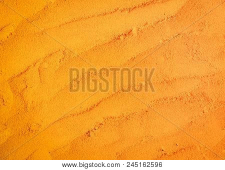 Turmeric Powder Texture For Background. Herbs Are Native To Southeast Asia.