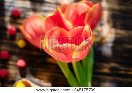 Blossoming Red Tulips On A Wooden Background With Sweets