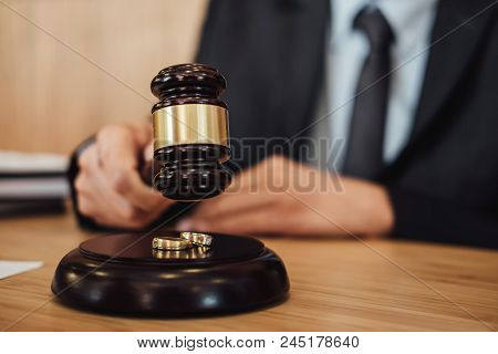 Two Golden Wedding Ring On Gavel, Marriage Divorce On Judge Gavel Deciding.