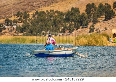 Woman Rowing On A Boat, Uros Island, Titicaca Lake, Peru