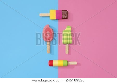 Ice Cream Popsicles Lollipops On A Pastel Blue And Pink Background Ready For Summer.  Wooden Toy Ice