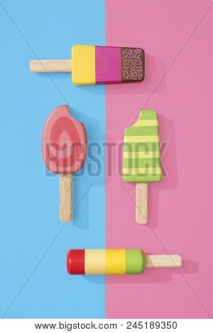 Ice Cream Popsicles Lollipops On A Pastel Blue And Pink Background Ready For Summer.  Wooden Toy Ice