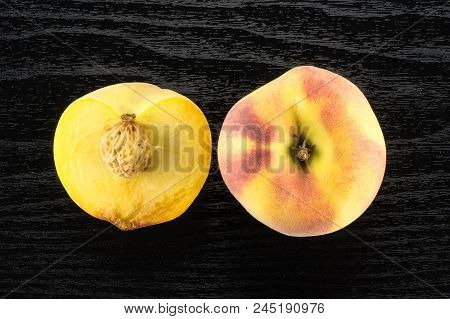 One Yellow Peach And A Half With A Drupe Flatlay On Black Wood Background