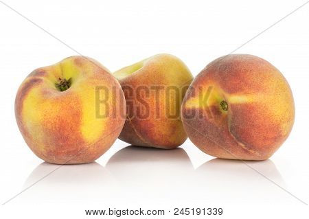 Three Ripe Yellow Peaches Isolated On White Background