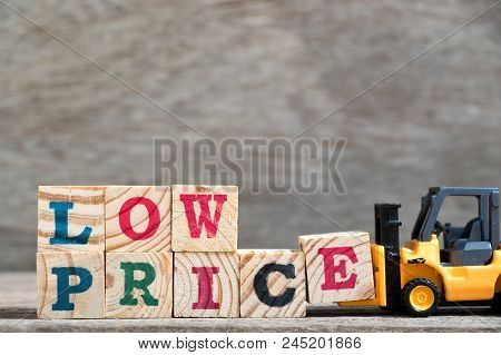 Toy Forklift Hold Letter Block E To Complete Word Low Price On Wood Background