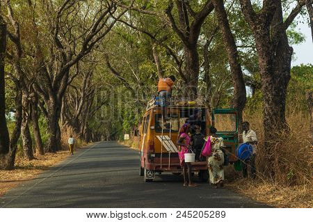 Cacheu, Republic Of Guinea-bissau - February 1, 2018: People Entering An Old Public Mini Bus In The 