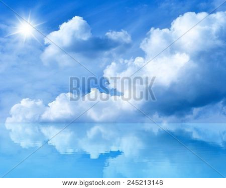 Summer Background With Blue Sky And White Clouds. Blue Sunny Sky Above The Water. Clouds And The Sun