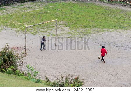 GHALEGAUN, NEPAL - CIRCA MAY 2018: chidren play football. The goal is made of tree branches.