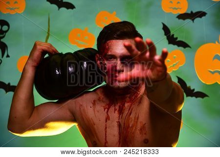 Macho With Torso, Pumpkins And Bats Decorations. Trick Or Treat And Sexy Body Concept. Man With Zomb