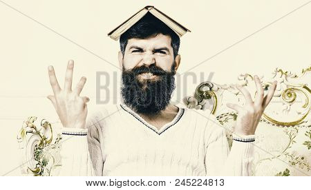 Mad Teacher Concept. Macho Sits With Open Book On Head, Like Roof. Man On Mad Face With Beard And Mu