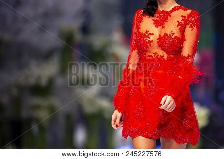 Sofia, Bulgaria - 28 March 2018: Female Model Walks The Runway In A Red Dress During A Fashion Show.