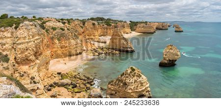 Panorama Of Praia Da Marinha On The South Coast Of Portugal In The Algarve On A Cloudy Day. The Clif
