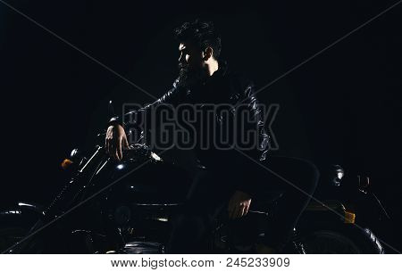 Brutality And Masculine Concept. Macho, Brutal Biker In Leather Jacket Stand Near Motorcycle At Nigh