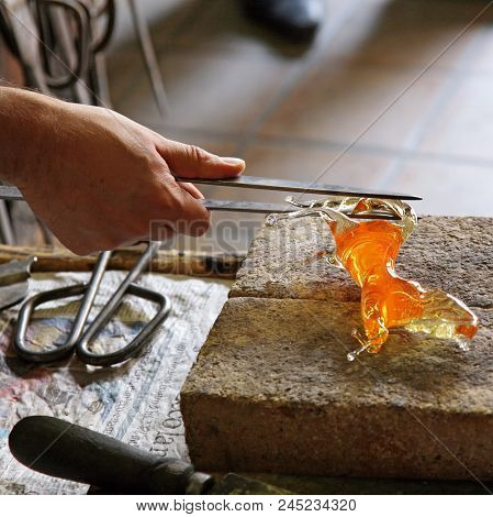 Glass Artist In Her Workshop Making Glassware