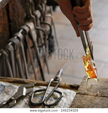 Glass Artist In Her Workshop Making Glassware