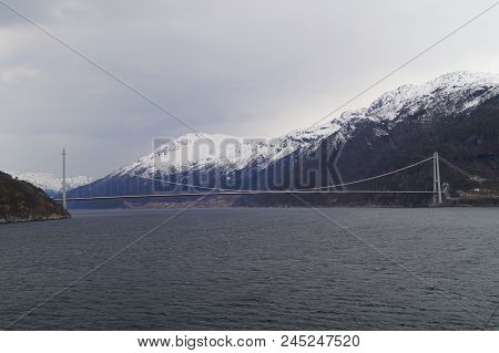 A Long Bridge Across The Hardangerfjord In Norway