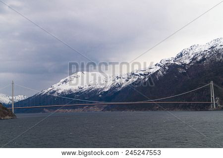 A Long Bridge Across The Hardangerfjord In Norway