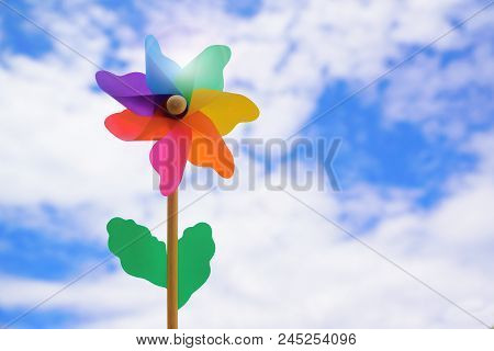 Windmill Against A Cloudy Sky And Some Sun Rays. Renewable Energies Metaphor And Empty Copy Space Fo