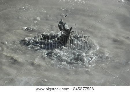Close Up Shot Of A Hot, Bubbling Mud Pool. A Bubble Of Mud Has Just Burst, And Is Surrounded By Ripp
