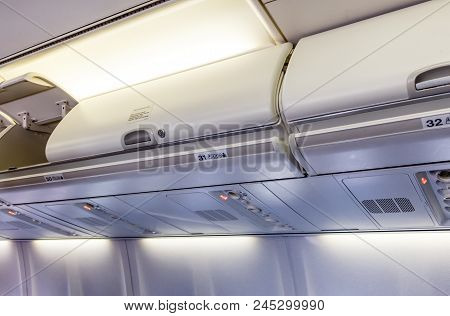 Overhead Compartment Closed And Opened - Detail Of An Commertial Airplane Cabin Interior