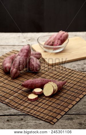 Raw Sweet Potato On Wooden Table