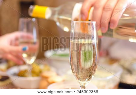 Woman Hand Holding A Wine Glass And Speaking The Toast. Congratulatory Speech.