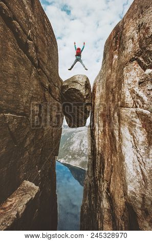 Brave Man Jumping Over Kjeragbolten Extreme Travel In Norway Kjerag Mountains Summer Vacations Adven