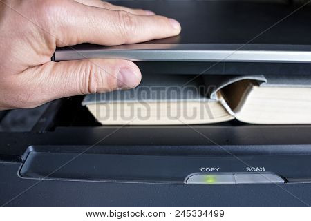 Man Hands Putting A Book Into A Copying Device To Make A Scanning